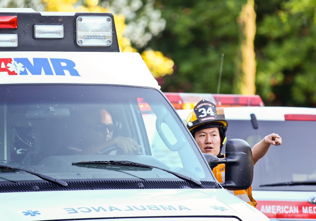 UC Davis Firefighter directs ambulance.