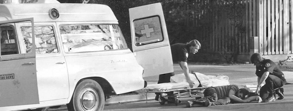 UC Davis Firefighters prepare to load patient into a waiting UC Davis Ambulance.