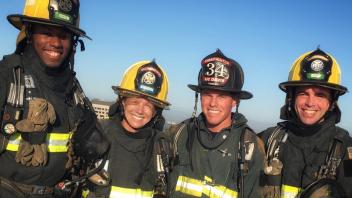 Firefighters wearing helmets and smiling