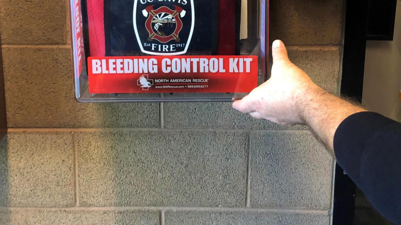 Red Stop the Bleed kit installed on the UC Davis Fire Department Wall.