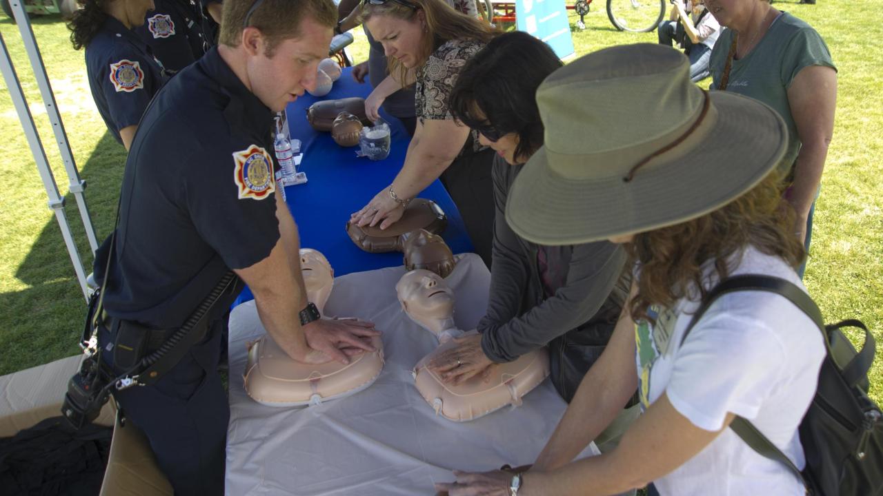 UC Davis Firefighters teach Hands-Only CPR at the UC Davis Farmers Market.