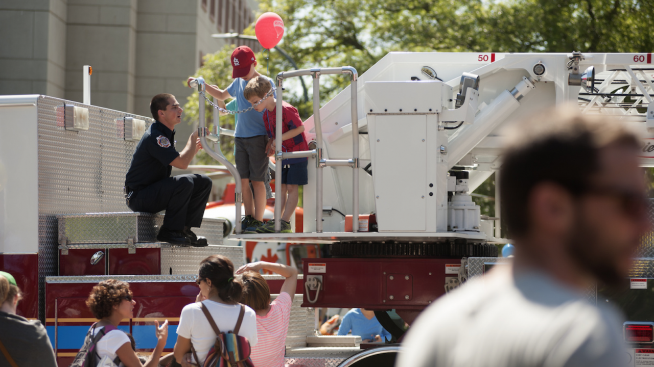 UC Davis Student Firefighter shows children around Truck 34 at Picnic Day 2016.