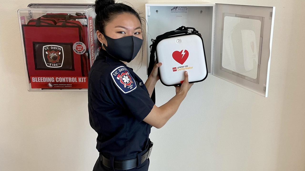 UC Davis Fire Student EMT checks campus AED cabinet