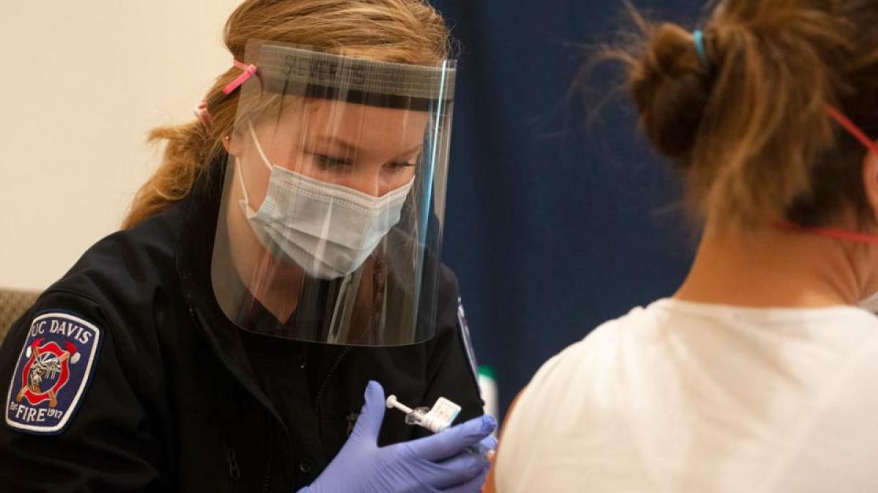 Amanda Sieverts, student EMT, gives a shot at the Davis campus vaccine clinic. (Gregory Urquiaga/UC Davis)