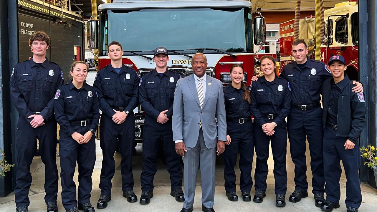 Chancellor Gary May (center) and members of the Fire Department stand in front of the new Ladder Fire Truck.
