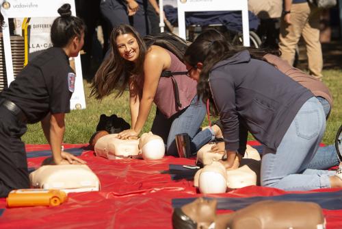 Not all heroes wear capes ... some learn hands-only CPR because a fellow Aggie may need help someday. Fire day on the quad