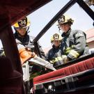 Student firefighter Nick White uses the Jaws of Life while Jack Casarez and Jack Gordon look on. (Karin Higgins/UC Davis)