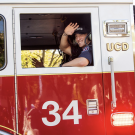 Student Firefighter waving from Fire Engine