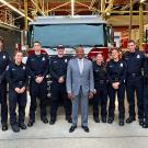 Chancellor Gary May (center) and members of the Fire Department stand in front of the new Ladder Fire Truck.