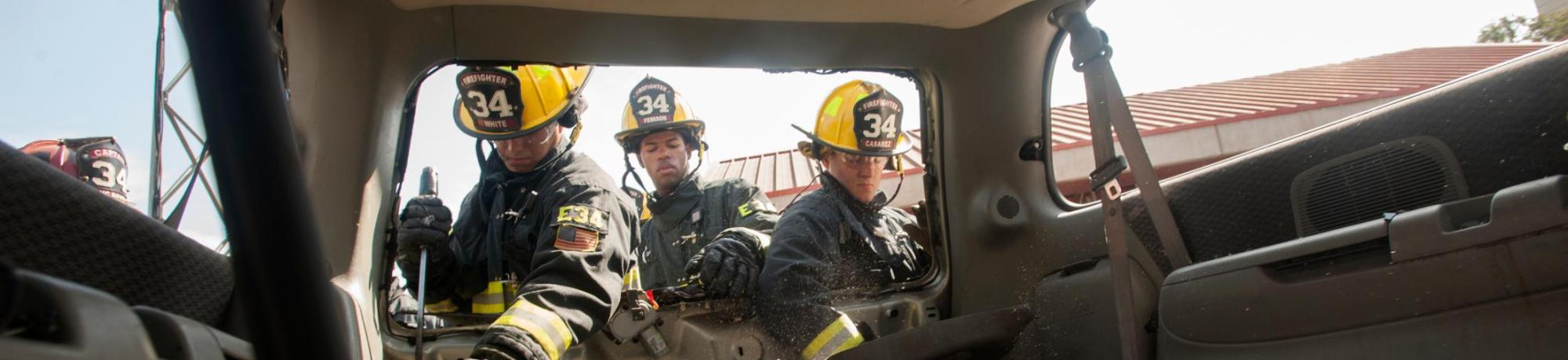 UC Davis Student Firefighters cut the doors off a car for training.