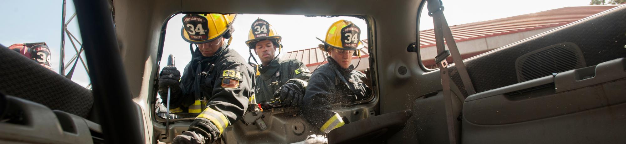 UC Davis Student Firefighters cut the doors off a car for training.