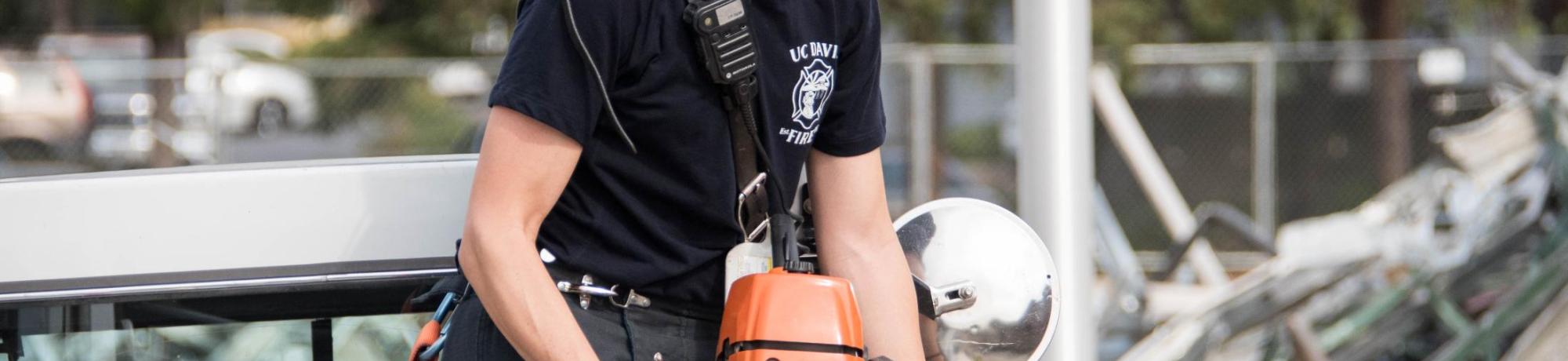 UC Davis Firefighter Corrie Beall replacing the chain saw on Truck 34.
