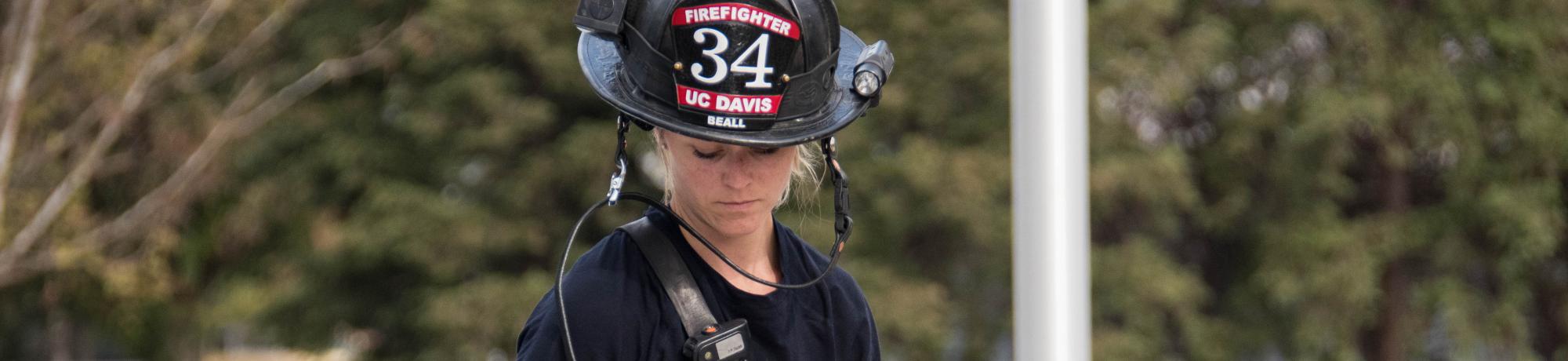 UC Davis Firefighter Corrie Beall replacing the chain saw on Truck 34.