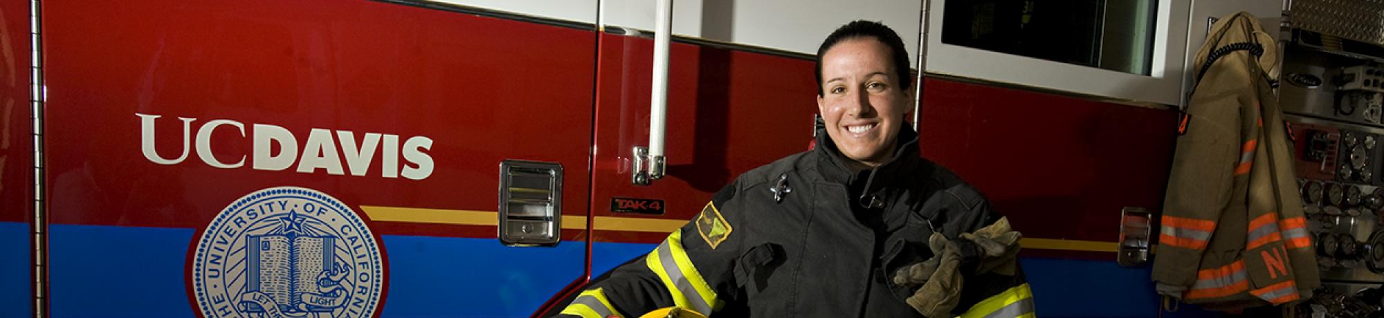 UCDFD Firefighter poses beside Engine 34