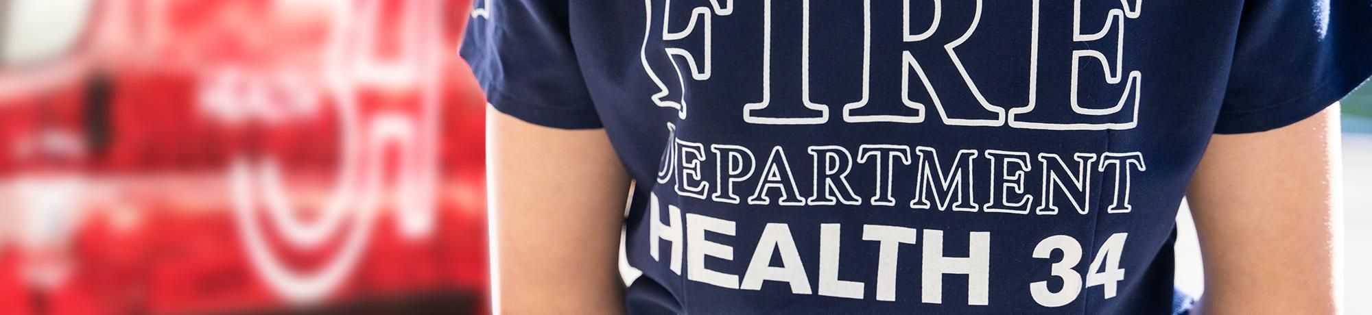 Banner image of person wearing Health 34 shirt.