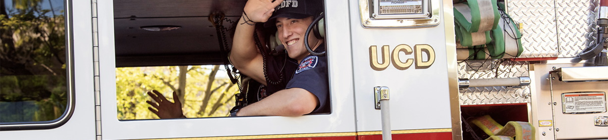 Student Firefighter waving from Fire Engine
